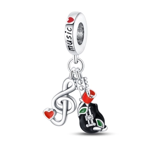 Close-up of music themed charm with silver guitar, red heart and enamel note pendant