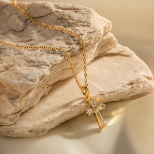 Detail eines 18K Gold Edelstahl-Kreuzanhängers mit eingelegten rechteckigen Zirkonia