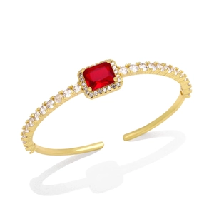Luxury gold open bangle with a central rectangular red zircon and sparkling accents