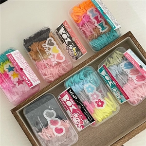 Colorful elastic hair bands in assorted cream tones inside a transparent storage box