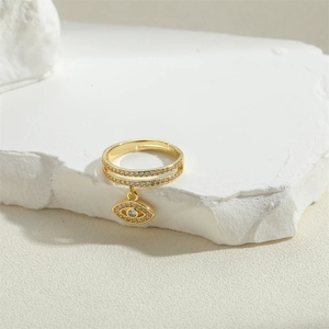 Golden double-row pave ring featuring a sparkling zircon evil eye dangle pendant charm