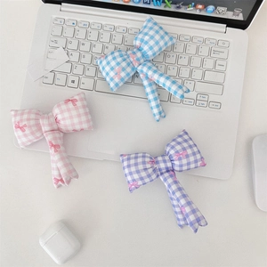 Detailed view of pink, blue and purple gingham bow accessories with ribbon print patterns
