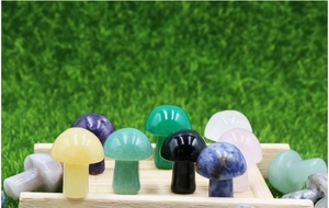 Close-up of 2cm mini gemstone crystal mushrooms in various colors on wooden tray