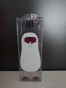 Detailed view of square transparent plastic milk carton cup with cute mole illustration