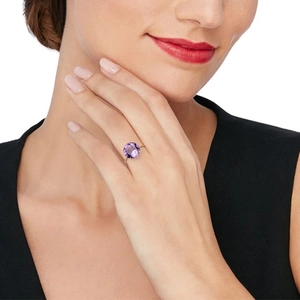Detailed view of an S925 silver ring featuring a luxury round cut purple gemstone on finger