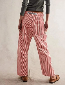 Detailed back view of red and white vertical stripe cargo pants with utility pockets