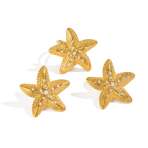 Elegant gold starfish jewelry set including ring and stud earrings with tiny crystals