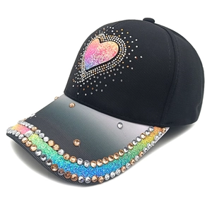 Detail of black cotton baseball cap with rainbow rhinestones and gradient heart pattern
