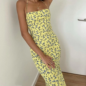 Detailed back view of a sexy yellow floral slip dress with open back and side slit