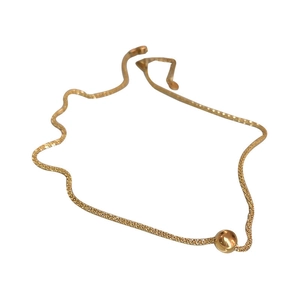 Minimalist titanium steel gold bead necklace with a fine woven chain on white background