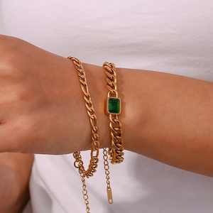 Vintage 18K gold plated Cuban chain bracelet set with green zircon stones on woman wrist