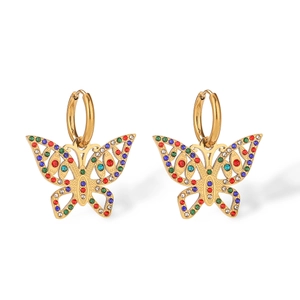 Detail of 18K gold butterfly earrings with colorful inlaid crystals and hoop design
