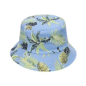 Close-up of tropical pineapple and palm leaf print on light blue cotton bucket hat