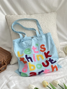 Blue canvas tote bag with colorful Chenille embroidery and silver metal snap button