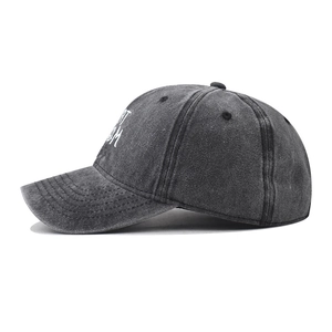 Close-up of vintage washed gray cotton baseball cap with white RT M letter embroidery