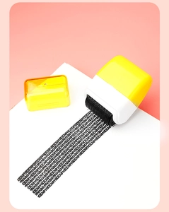Yellow identity theft protection roller stamp creating black privacy coverage on paper