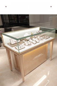 Detail view of premium jewelry display case with gold metal frame and LED lighting