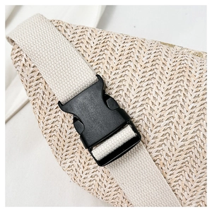 Detail of the woven straw texture and adjustable black plastic buckle on the waist bag