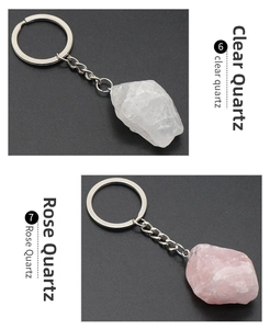 Macro detail of natural clear and rose quartz raw stone keychains with silver metal rings