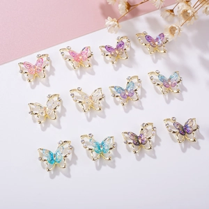 Detail of 3D butterfly nail charms with aurora wings, gold alloy edges, pearls and crystals