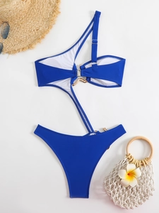 Detailed view of royal blue one-piece swimsuit with cutout waist and gold ring hardware