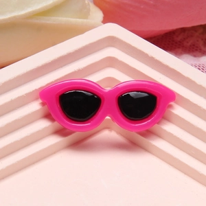 Close-up of pink resin miniature sunglasses accessory on a display stand for DIY crafts