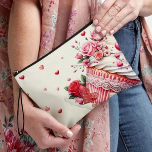 Linen makeup bag with Valentine cake print and pink roses held by a model