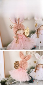 Detail of plush angel rabbit ornament with gold sequins and sparkly feather wings