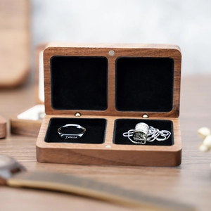 Macro detail of black walnut jewelry box with two compartments and soft black lining