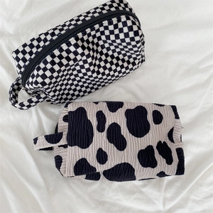 Vintage velvet makeup bags in checkered and cow print with bubble fabric texture