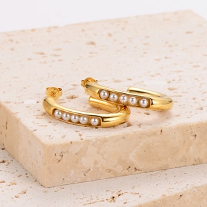 French retro gold C-shaped hoop earrings with elegant inlaid pearls on stone tray
