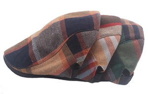 Detail of adjustable metal buckle and colorful vintage plaid patterns on beret hats