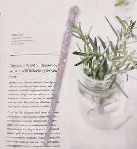 Close-up of a light purple acetate hair stick with spiral twist and marbled shell texture