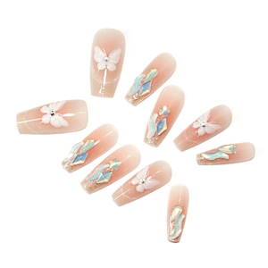 Nude pink gradient coffin nails with 3D white butterfly patterns and aurora crystals