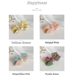 Detail of acetate bow hair clips in marble and striped patterns with handmade finish