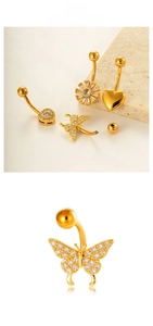 Detailed view of gold navel rings featuring sunflower, heart, and butterfly charms with zircons