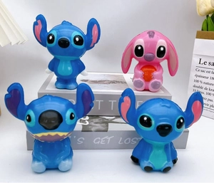 Close-up of Stitch and Angel figurines set on a decorative background for desk display