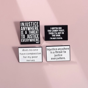 Set of 4 black and white enamel pins with inspirational quotes on pink background