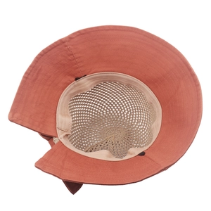 Detail view of brick red sun hat with breathable beige mesh interior and wide brim
