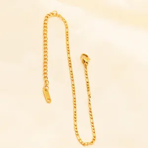 Minimalist gold plated stainless steel Figaro anklet with lobster clasp on silk fabric