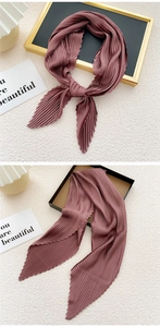 Detail of elegant pleated solid pink silk scarf with wavy edges on artistic background