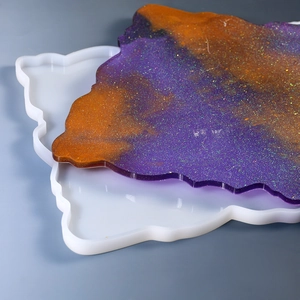 Detailed view of irregular silicone resin tray mold with colorful glittery sample