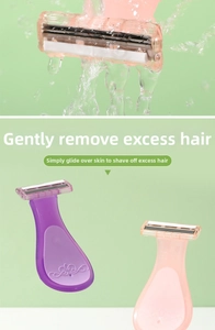 Close-up of portable pink razor under running water showing easy rinse feature