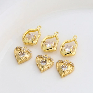 Macro view of gold-plated copper heart pendants with sparkling cubic zirconia inlay