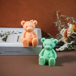Cute bear aroma candle molds with bow and flower details in orange and green tones