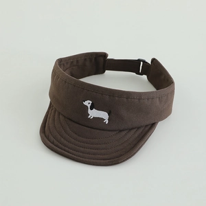 Detail of adjustable strap and dog embroidery on brown sun visor cap for kids