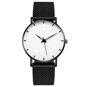 Macro shot of minimalist white dial with black mesh strap and sleek metal case textures