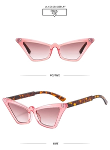 Detailed view of pink cat-eye sunglasses with tortoiseshell temples and brown gradient lenses