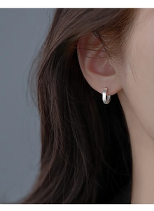 Macro shot of S925 sterling silver hoop earring with brushed texture and hallmark