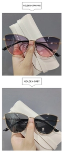 Detail of metal cat eye sunglasses in gold-pink and gold-grey gradient lenses